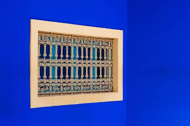 Window in a blue wall at Jardin Majorelle