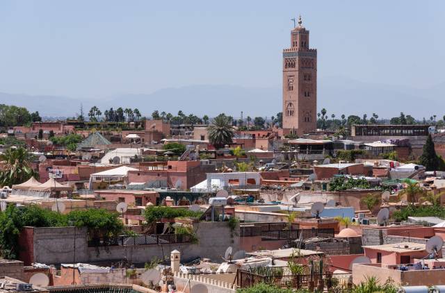 Roofs, the tower of Koutoubia mosque and a glimpse of the Atlas mountains in the back.