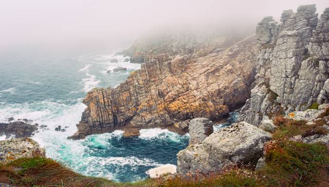 The Pointe de Pen-Hir with its distinctive rock formations in heavy fog.