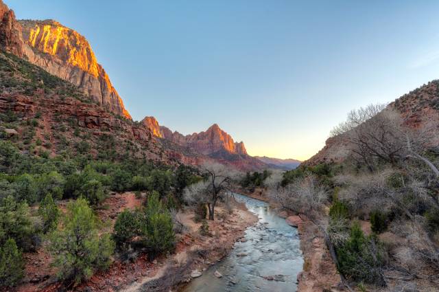 A view along the Virgin River valley with the Watchman mountain in the back at sunset